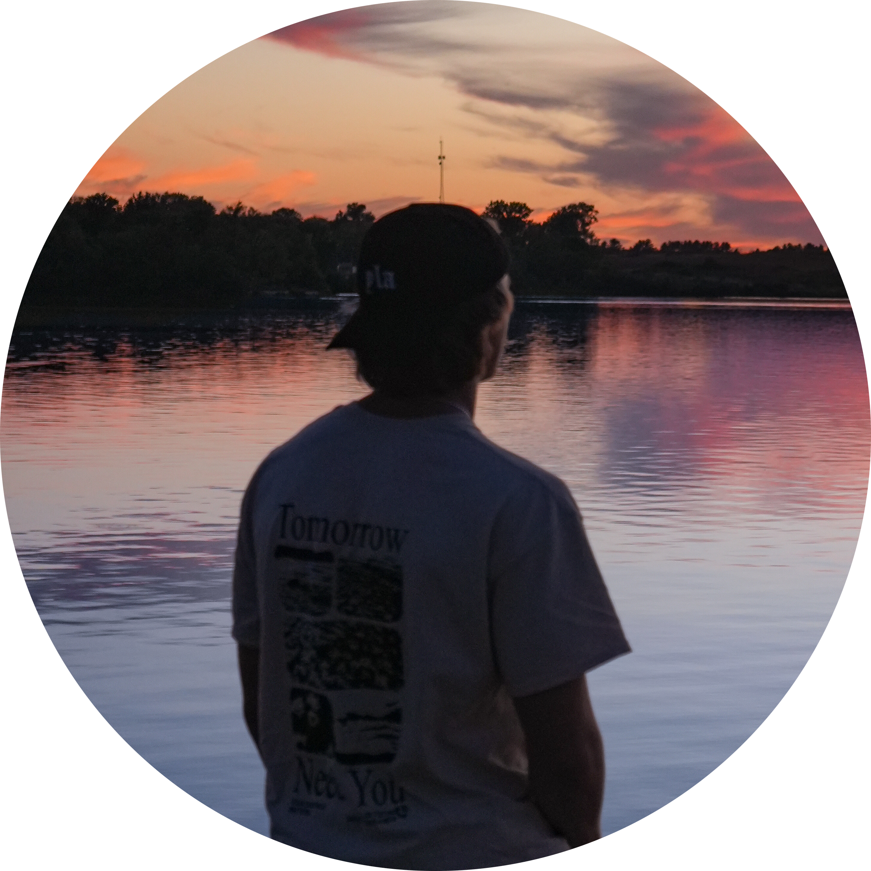 Grant looking over a lake at sunset